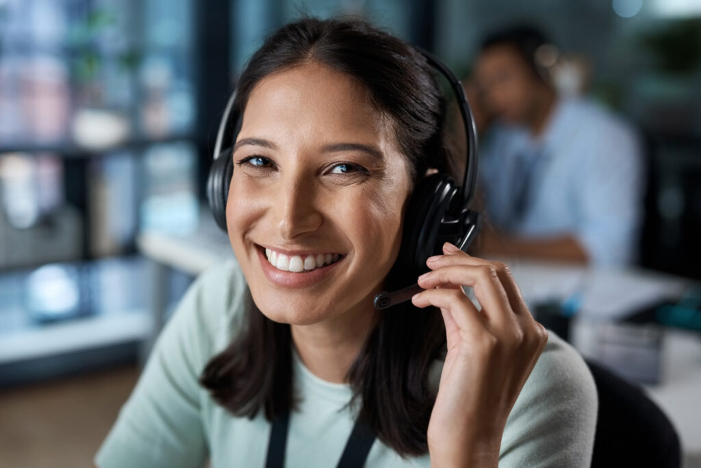 Redfin POS customer support woman wearing a headset and smiling at the viewer.